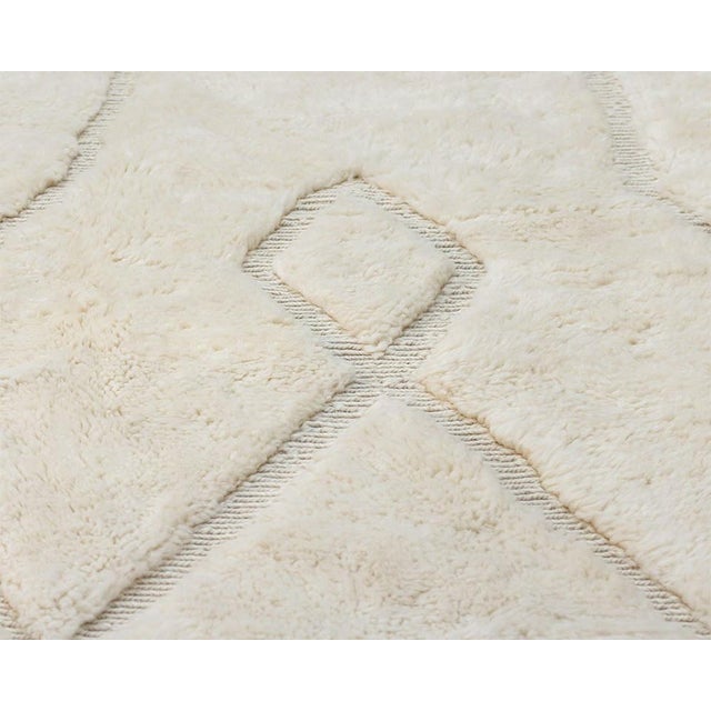 Elegant hand-knotted wool rug in Ivory, featuring subtle geometric patterns with plush pile, finished with classic...