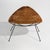 A 1950s woven rattan magazine rack with a metal frame, distinguished by its sculptural silhouette that combines the...
