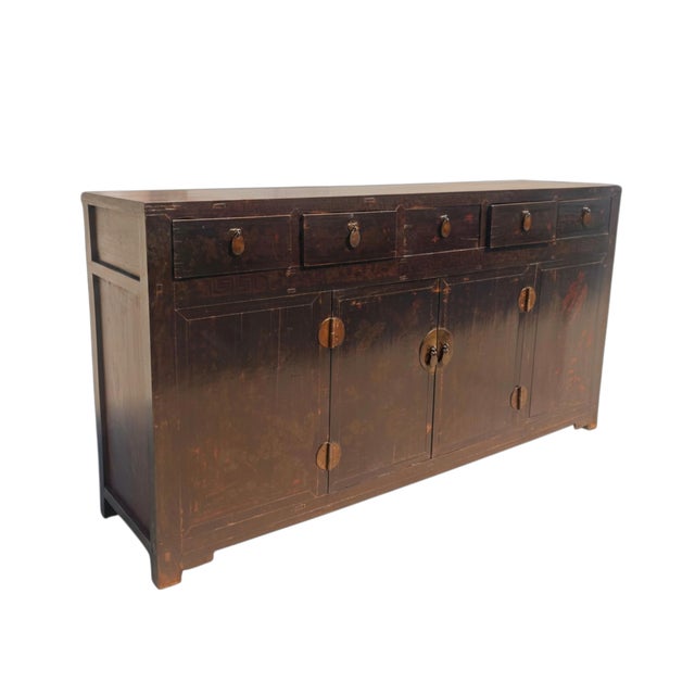 Dating to circa 1846, this large antique Chinese sideboard has a deep red-brown hue, a beautifully aged surface, and an...