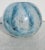 Blue, white, and bubbles swirling around the ball vase, moving deep inside the thick wall and bubbling up inside the vase....