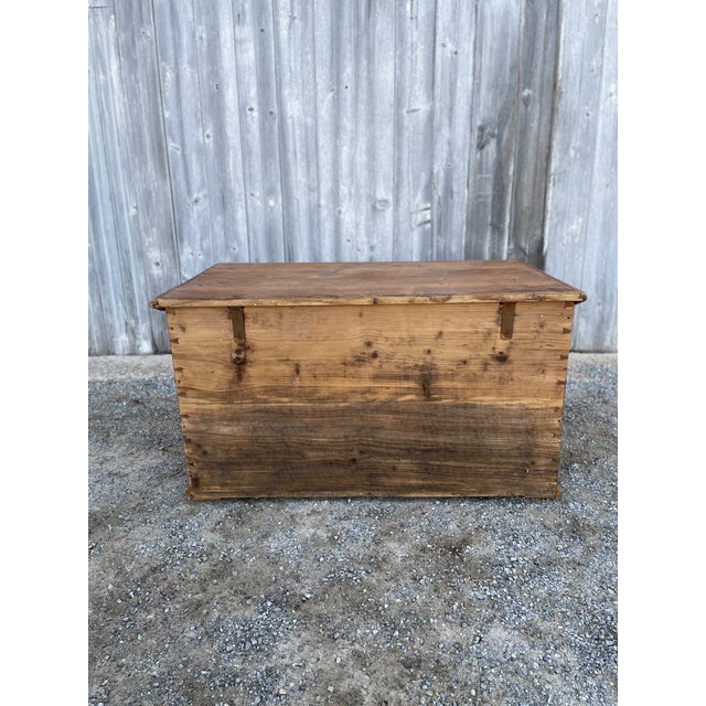 Pine blanket chest with candle box and iron handles, carved accents.