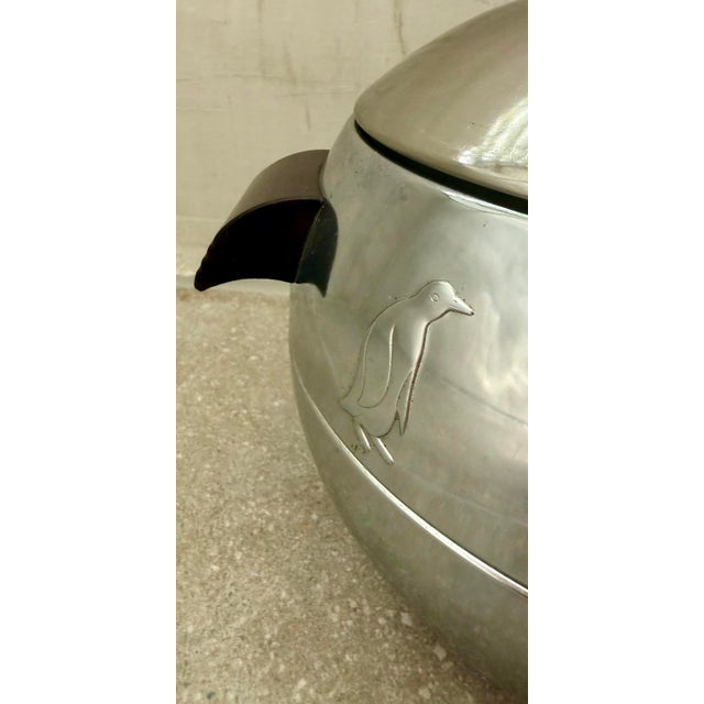 Iconic vintage original West Bend Penguin hot and cold server/ice bucket featuring a chrome finish, embossed penguin...