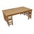 Vintage rattan coffee table featuring a woven cane top framed by a warm natural rattan structure. The architectural base...