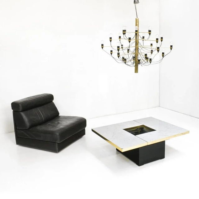 A Paul Michel 1970s coffee table executed in white marble with brass trim. This combination in materials is rarely seen on...