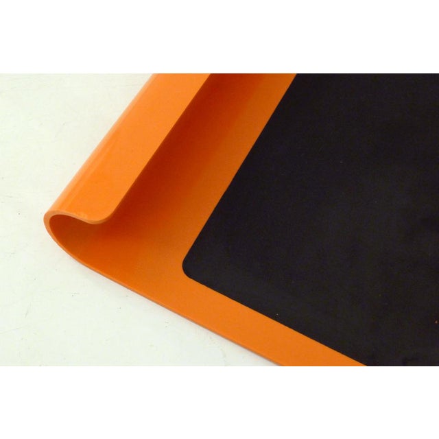 Wall-mounted blackboard, for writing with chalk (and erasing) endlessly; rectangular portrait format: large bright orange...