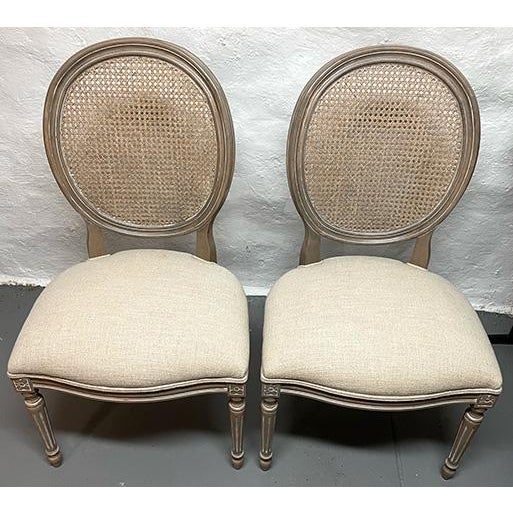 Enhance your space with this beautifully upholstered pair of contemporary French-style side chairs from Ethan Allen....