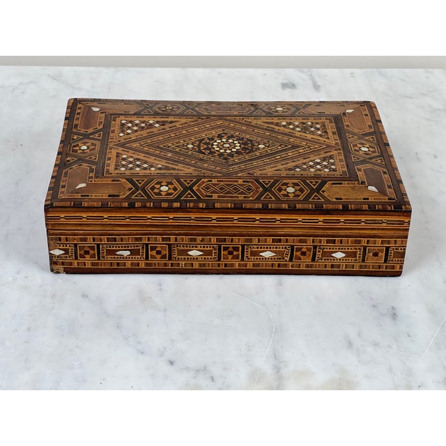 This finely made early 20th century khatam inlaid jewelry box is a beautiful example of Middle Eastern decorative...