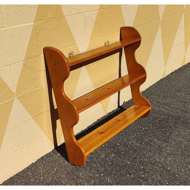 This vintage wooden wall shelf, with 3 shelves made of maple wood, looks handmade and elegant in style, perfect for...