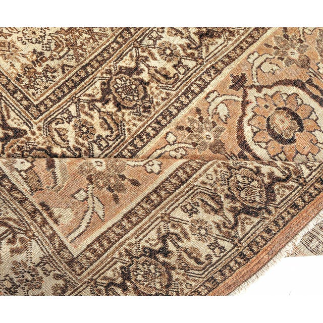 This antique rug was made in the highly esteemed Tabriz weaving center. Its design is a balanced composition of classic...