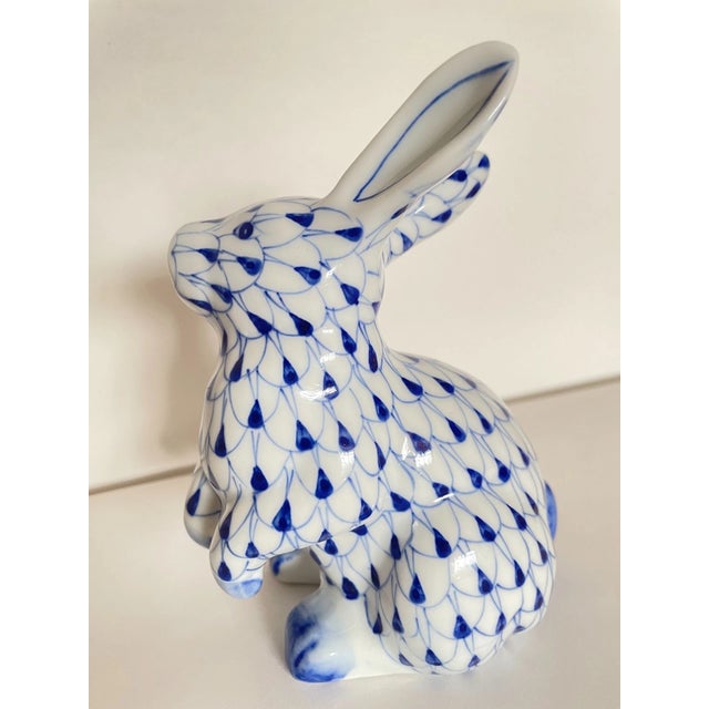 A charming vintage porcelain bunny figurine by Andrea by Sadek, featuring the iconic blue-and-white fishnet pattern...