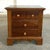 This cherry nightstand features a warm finish, paneled drawer fronts, and classic wood knobs for a clean, traditional...