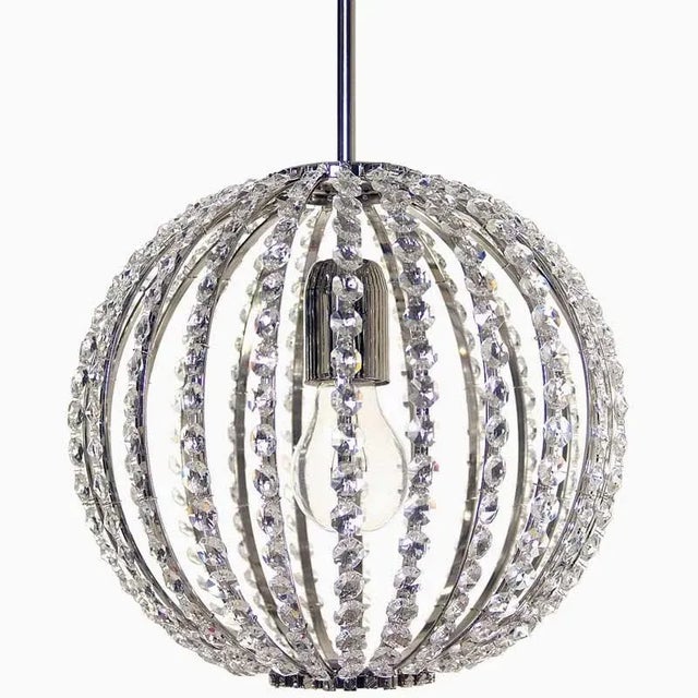 A spherical chandelier with stretched crystal chains. Standard length from ceiling: 75cm. Surface treatment nickel, Bulb:...