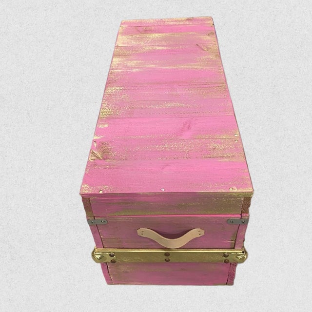 Beautifully handcrafted steamer trunk in pink with gold highlights. Made with reclaimed wood, this chest is a striking...