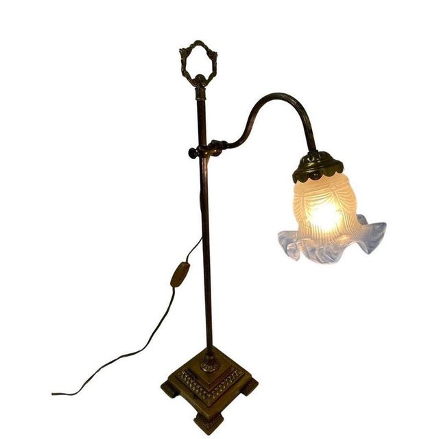 Art Nouveau lamp made in France. Comes with a pressed glass shade, and has been rewired. The base is an bronze / brass...