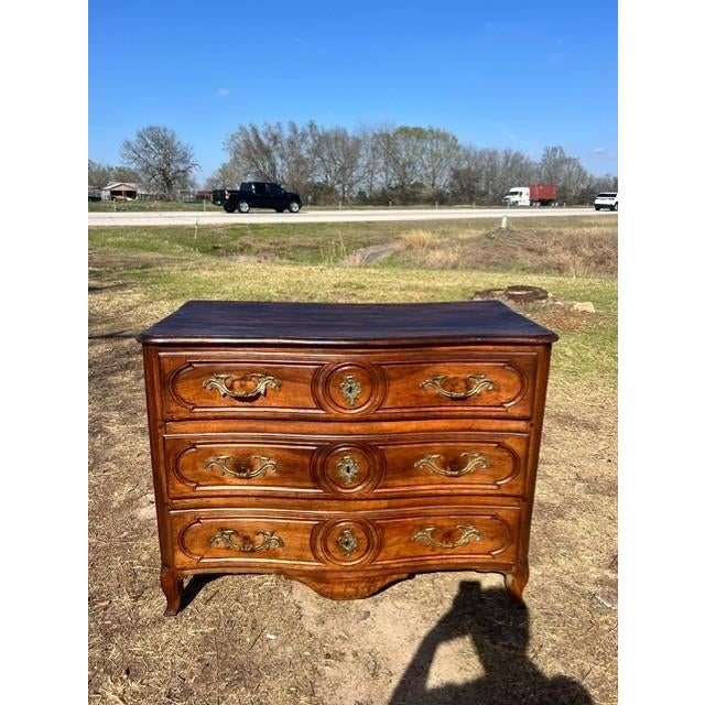 a Large 18th Century French Louis XV Commode from Lyon France. Made of solid walnut, the wood has been finished with a...