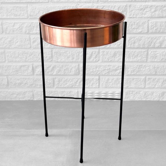 A modernist flower stand produced by the Swedish manufacturer Ystad Metall in the 1950s. The design features a circular...
