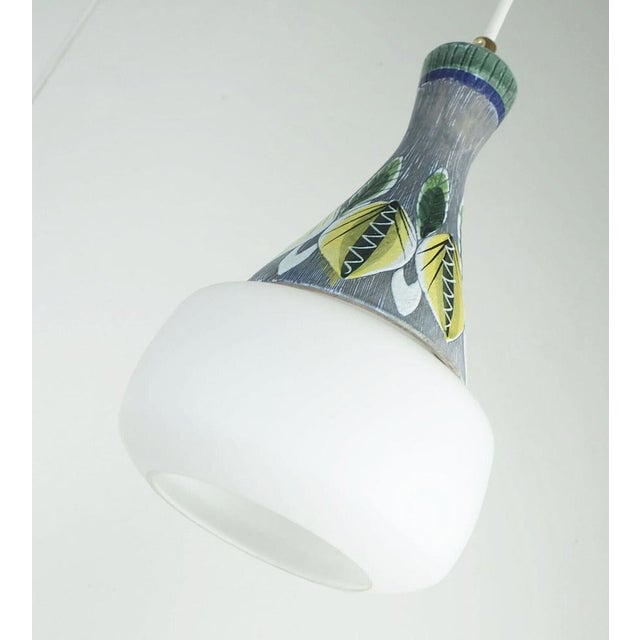 Exceptionally beautiful 1950s to early 1960s pendant light. Origin probably Scandinavia. Shades made of white satin glass...