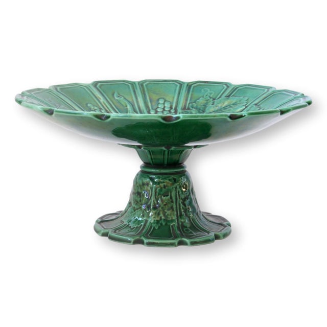 Early 20th century French majolica compote by Sarreguemines featuring a richly glazed deep green finish and classical...