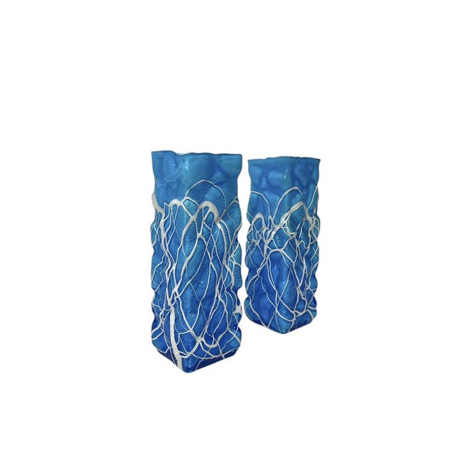 A set of 2 handblown double-walled blue vases, featuring “training” glass (the white droplets) Made in Italy in the 1980s....