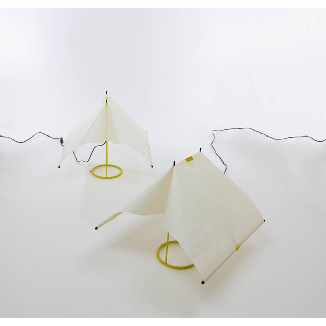 A pair of table lamps from the 'Le Falene' series designed by Piero De Martini in 1980 and produced by Arteluce. The main...