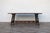 A striking Antique Spanish Revival trestle dining table crafted from solid wood, featuring a beautifully aged plank top...