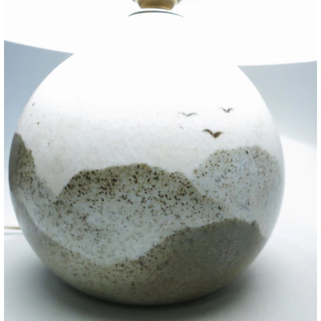 This porcelain table lamp features a mountain landscape and was designed by ceramist Yves Mohy for Virebent circa 1975....