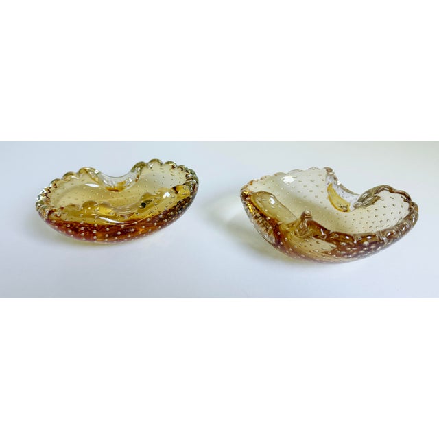 A wonderful pair of controlled-bubble bellicante-style Murano ashtrays or small catch-all bowls featuring ruffled edges...