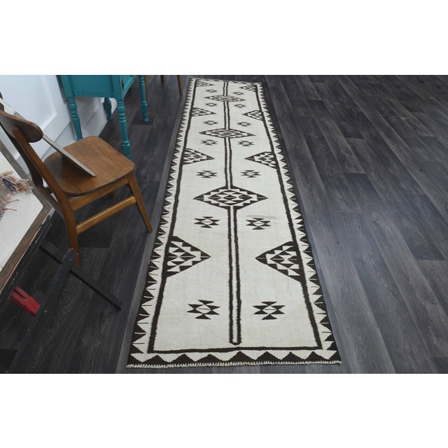 Vintage Hand-Knotted runner rug is a semi-antique vintage runner rug. The '70s Eastern region of Anatolia's unique rug is...