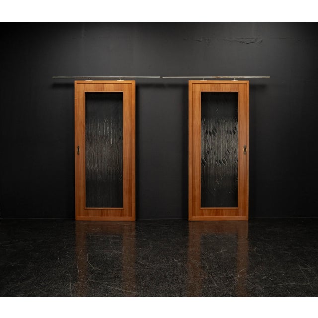 Handcrafted by a carpenter in walnut and mahogany, with a floral glass insert. This elegant sliding door set from the...