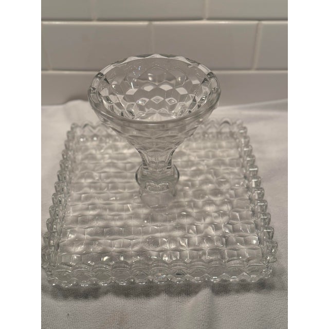 A striking vintage Fostoria Glass Company pedestal cake stand in the iconic American pattern, featuring Fostoria’s...