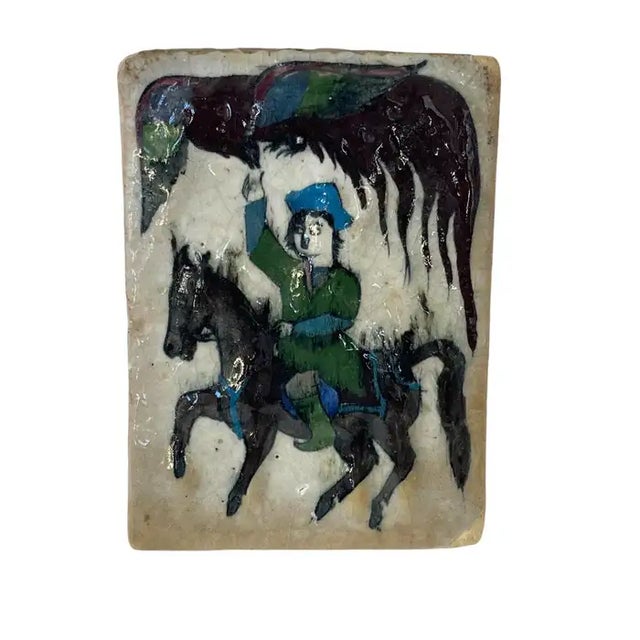 Antique Persian Qajar tile, handmade rendered in clay ceramic with a hand applied glaze featuring a scene of a falconer on...