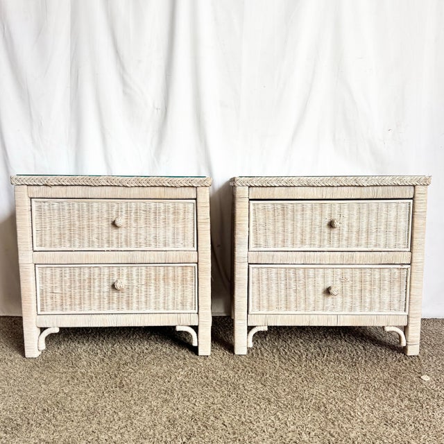 A charming pair of Boho Chic nightstands, beautifully crafted in white-washed wicker with braided trim and original glass...