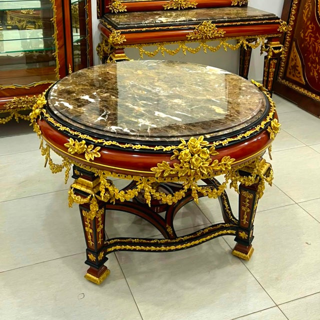 Make a dramatic statement with this large French Empire-inspired center table, crafted from substantial hardwood and...