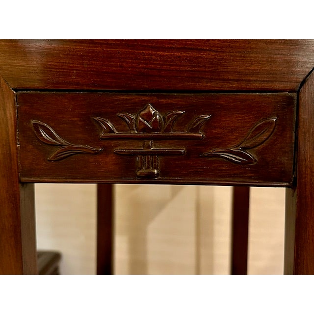 This set of nesting wooden side tables is solidly constructed. The type of wood is presumed to be rosewood. The set has...