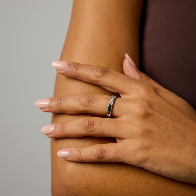 This Art Deco inspired eternity band is a striking blend of geometry, contrast, and vintage-inspired design. Alternating...