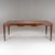 Exceptional dining table featuring a rectangular top and tapered legs. The apron is distinctively shaped with trapezoidal...