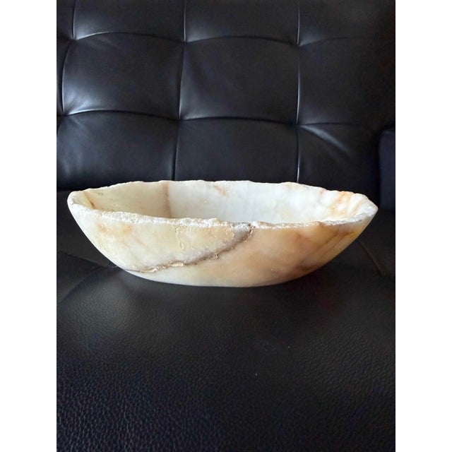 Beautiful low-profile bowl carved from natural onyx, with a softly irregular organic form and luminous ivory coloring. The...