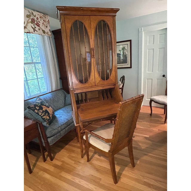 This Faux Bamboo and woven rattan secretary desk is by American of Martinsville from the 1970’s. Form and function are...