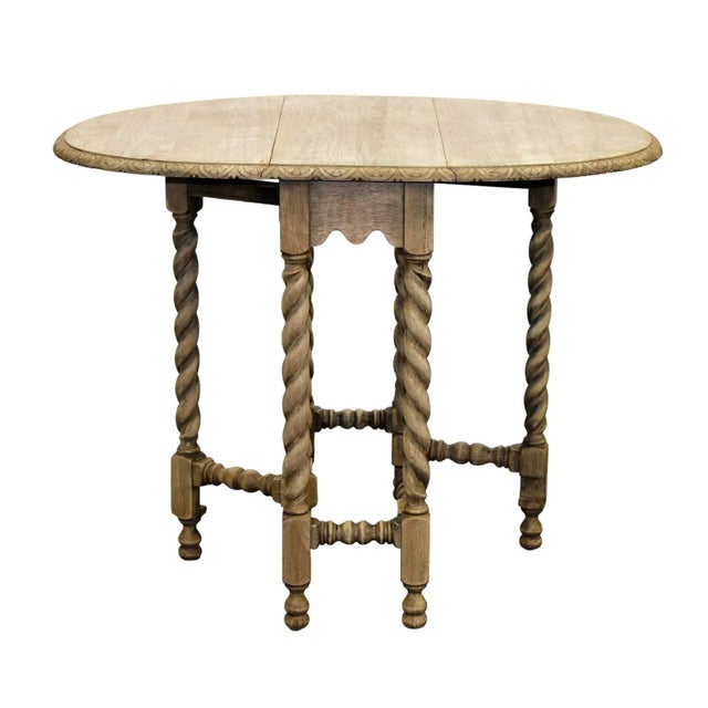 This charming French gate-leg drop-leaf table showcases elegant barley twist legs and a versatile design, seamlessly...