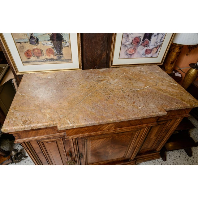 19th century French side cabinet. With oak secondary wood.The cabinet features fine parquetry inlays. It is designed with...