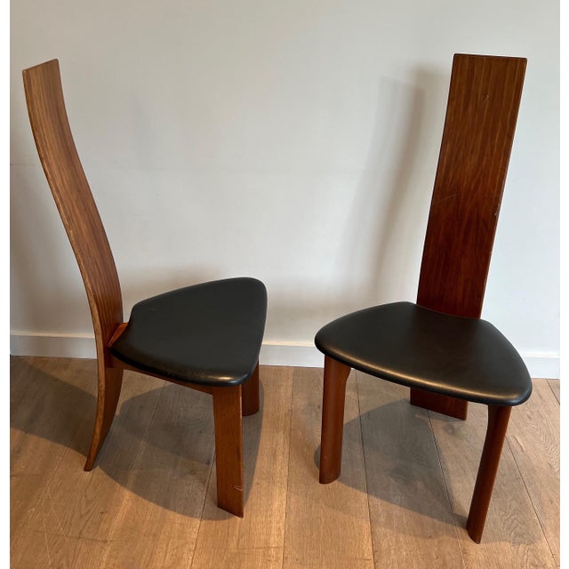This pair of chairs is made from exotic wood with black leather seats. This is a French work. Circa 1970