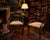 An elegant and highly decorative pair of English mahogany armchairs dating from the transition between the late Regency...