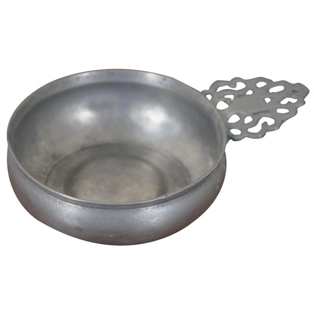 Antique circa 18th century unmarked pewter porringer or tastevin with bellied sides, bossed base, triangular ear bracket...