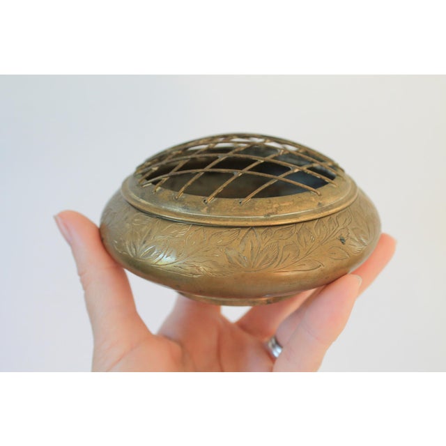 Vintage etched brass flower frog. Made in India. Makers mark on the bottom. Patina to brass. Pictured.