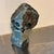 This is a hand-carved owl sculpture made from stone. It is made of serpentine stone and originates from Zimbabwe. The...