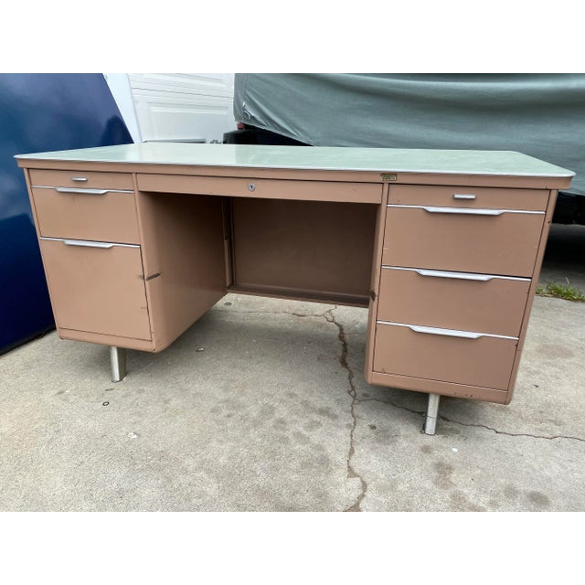 General fireproofing company vintage metal tanker desk in light brown color, with file drawer and three smaller drawers,...