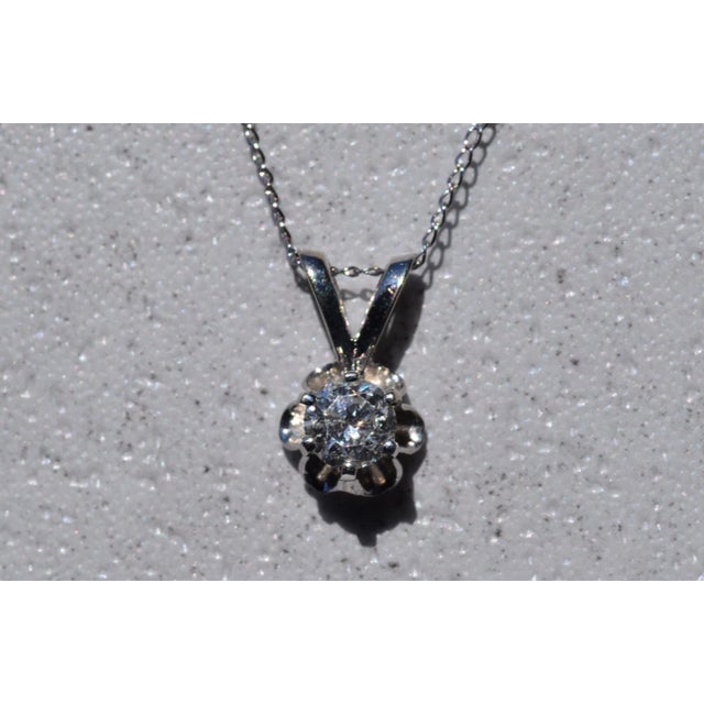The Knights Ferry: Buttercup Solitaire Natural Diamond Necklace. The necklace features a 0.45 carat round brilliant cut...