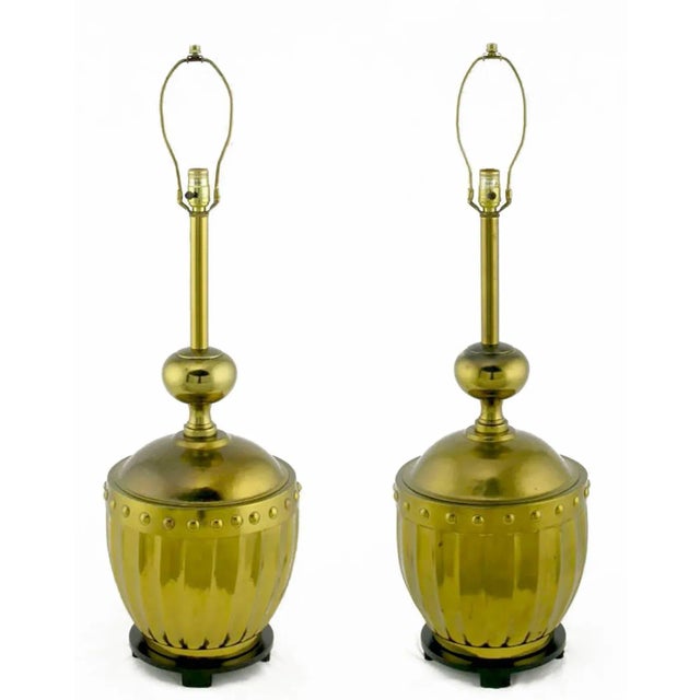 Large studded and fluted brass table lamps from the best years of Stiffel, the fine lamp maker. Black lacquered bases...