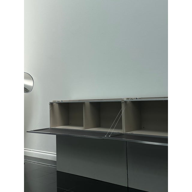 PAB wall-mounted storage unit by Studio Kairos for B&B Italia, featuring a suspended, architectural form defined by clean...
