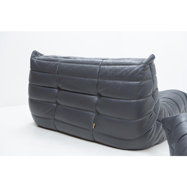 A two-piece togo seating set designed by michel ducaroy for ligne roset, comprising a two-seater sofa and lounge chair,...